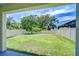 Enjoy the view from the covered patio, featuring a large grassy backyard and privacy fence at 828 Terra Vista St, Brandon, FL 33511