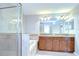 Bathroom with a tiled shower, soaking tub, and double sink vanity at 828 Terra Vista St, Brandon, FL 33511