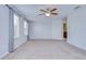 A spacious main bedroom with carpet, ceiling fan, and access to the bathroom at 828 Terra Vista St, Brandon, FL 33511