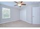 Comfortable bedroom with neutral carpet and ceiling fan, plus a closet for storage at 828 Terra Vista St, Brandon, FL 33511