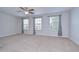 Spacious bedroom featuring three windows that provide ample natural light and a ceiling fan at 828 Terra Vista St, Brandon, FL 33511
