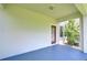 Covered patio space with an entryway door, a window and view to backyard at 828 Terra Vista St, Brandon, FL 33511