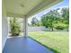 View of a spacious, grassy backyard with a white fence from the covered patio at 828 Terra Vista St, Brandon, FL 33511