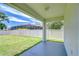 Covered patio overlooks a large backyard with white fencing and a glimpse of a screened pool area at 828 Terra Vista St, Brandon, FL 33511