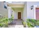 Inviting front entrance with a covered porch and brick pavers leading to the front door at 828 Terra Vista St, Brandon, FL 33511