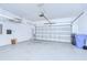Spacious garage with overhead storage and a white automatic garage door at 828 Terra Vista St, Brandon, FL 33511