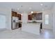 Bright kitchen featuring granite countertops, a center island, stainless steel appliances, and dark wood cabinetry at 828 Terra Vista St, Brandon, FL 33511