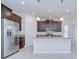 Well-lit kitchen features granite countertops, dark cabinets, stainless steel appliances, and a functional kitchen island at 828 Terra Vista St, Brandon, FL 33511