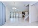Open-concept living area showcasing access to the kitchen, stairs, and lots of natural light from the large windows at 828 Terra Vista St, Brandon, FL 33511