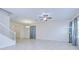 Spacious living room with tile floors, a ceiling fan, and natural light from large windows at 828 Terra Vista St, Brandon, FL 33511