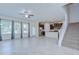 Living room features tile floors, open to a kitchen with stainless appliances, and a staircase at 828 Terra Vista St, Brandon, FL 33511