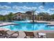 Community pool with water features, palm trees, and lounge chairs, perfect for relaxation and recreation at 828 Terra Vista St, Brandon, FL 33511