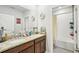 Bathroom featuring a double vanity with granite countertops and a shower-tub combination for a luxurious experience at 8305 Praise Dr, Tampa, FL 33625