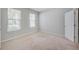 Bright bedroom with carpet, with large windows and closet door, offering a cozy retreat at 8305 Praise Dr, Tampa, FL 33625
