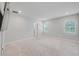 Spacious, light-filled bedroom with two windows, neutral carpet, and a fresh, clean aesthetic perfect for relaxation at 8305 Praise Dr, Tampa, FL 33625