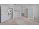 Neutral bedroom showcasing double doors, a frosted glass door, and neutral carpeting at 8305 Praise Dr, Tampa, FL 33625