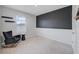 Stylish bedroom with a dark accent wall, unique wainscotting, and a cozy chair, offering a modern and comfortable space at 8305 Praise Dr, Tampa, FL 33625