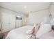 Bedroom with a white dresser, TV, bed with pillows, and closet doors and a doorway to another room at 8305 Praise Dr, Tampa, FL 33625