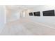 Spacious bonus room with modern ceiling fan and three televisions mounted to the wall at 8305 Praise Dr, Tampa, FL 33625