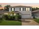 Charming two-story home with manicured lawn, lush landscaping, and a welcoming facade at 8305 Praise Dr, Tampa, FL 33625