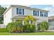Charming two-story home featuring classic architectural details and lush landscaping, enhancing curb appeal at 8305 Praise Dr, Tampa, FL 33625