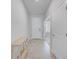 Neutral hallway featuring tile floors, a console table, and access to various rooms at 8305 Praise Dr, Tampa, FL 33625