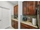 Kitchen featuring granite countertops, wooden cabinets, and modern appliances and fixtures at 8305 Praise Dr, Tampa, FL 33625