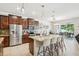 Well-appointed kitchen with an island featuring barstool seating, stainless steel appliances, and pendant lighting at 8305 Praise Dr, Tampa, FL 33625