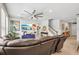 Stylish living room featuring a large sectional, ceiling fan and tasteful décor creating a comfortable space at 8305 Praise Dr, Tampa, FL 33625