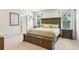Inviting main bedroom with a wooden bed frame, comfortable bedding, and natural light creating a serene atmosphere at 8305 Praise Dr, Tampa, FL 33625