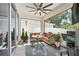 Cozy covered patio with comfortable seating, ceiling fan, and stylish decor, perfect for relaxing outdoors at 8305 Praise Dr, Tampa, FL 33625