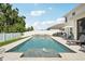 Backyard pool surrounded by an expansive patio, perfect for lounging and outdoor fun at 8305 Praise Dr, Tampa, FL 33625
