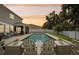 Scenic view of a backyard pool with comfortable seating, perfect for enjoying sunsets at 8305 Praise Dr, Tampa, FL 33625
