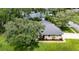 Aerial view of the home with a mature trees and well-maintained lawn at 8901 Eagle Watch Dr, Riverview, FL 33578