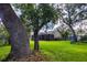 Beautiful backyard with a screened lanai, mature trees, and well-maintained lawn at 8901 Eagle Watch Dr, Riverview, FL 33578
