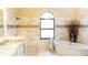 Bathroom with free standing tub, travertine tile, and granite countertops at 8901 Eagle Watch Dr, Riverview, FL 33578