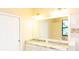 Bright bathroom with double vanity, granite countertop, and large mirror at 8901 Eagle Watch Dr, Riverview, FL 33578