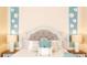 Bright bedroom featuring decorative pillows, side tables with lamps, and flower decor at 8901 Eagle Watch Dr, Riverview, FL 33578