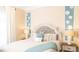 Bedroom with side tables, decorative floral wall decor, and large window at 8901 Eagle Watch Dr, Riverview, FL 33578