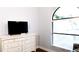 A bright bedroom with a large window and a modern white dresser at 8901 Eagle Watch Dr, Riverview, FL 33578