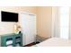 Bedroom with a TV, cabinet, bench, and natural light at 8901 Eagle Watch Dr, Riverview, FL 33578