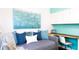 Cozy bedroom with blue accent wall and an integrated desk space and overhead storage at 8901 Eagle Watch Dr, Riverview, FL 33578