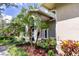 Close-up of the home's exterior, showcasing the arched windows and landscaped garden at 8901 Eagle Watch Dr, Riverview, FL 33578