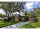View of the home's side, featuring a long driveway and tasteful landscaping at 8901 Eagle Watch Dr, Riverview, FL 33578