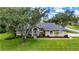 Charming one-story home with a beautifully landscaped front yard and arched entryway at 8901 Eagle Watch Dr, Riverview, FL 33578