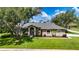 Attractive home with a lush lawn, mature trees, and inviting curb appeal at 8901 Eagle Watch Dr, Riverview, FL 33578