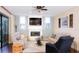 Cozy living room boasts a fireplace, comfortable seating, and plenty of natural light at 8901 Eagle Watch Dr, Riverview, FL 33578