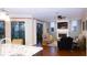 Comfortable living room boasts a fireplace, a ceiling fan, hardwood floors, and sliding doors to the patio at 8901 Eagle Watch Dr, Riverview, FL 33578