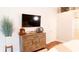 Comfortable main bedroom with a wooden dresser, TV, and a view of the outdoor patio at 8901 Eagle Watch Dr, Riverview, FL 33578