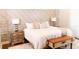 Stylish bedroom features a decorative wall, plush bedding, and a bench at the foot of the bed at 8901 Eagle Watch Dr, Riverview, FL 33578